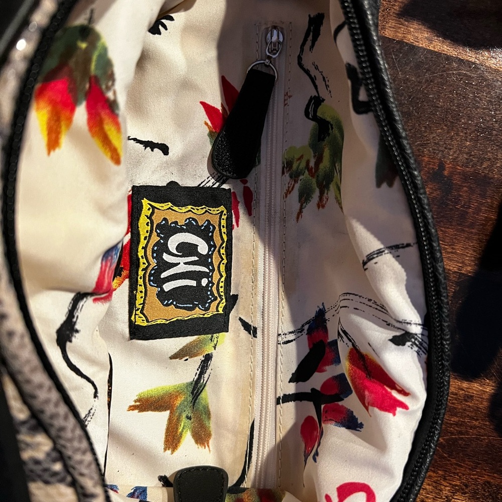 Chi bag with faux snake skin andblack outer panel